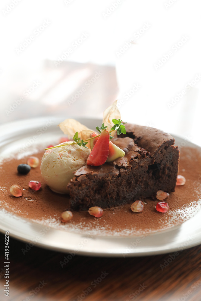 Chocolate cake with ice cream dessert on wood table Chocolate cake with ice cream dessert on wood table