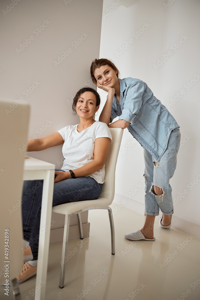 Positive delighted women spending weekend at home Positive delighted women spending weekend at home