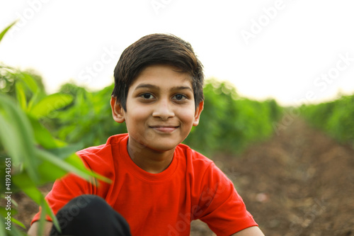 cute indian child at agriculture field