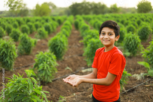 cute indian child at agriculture field