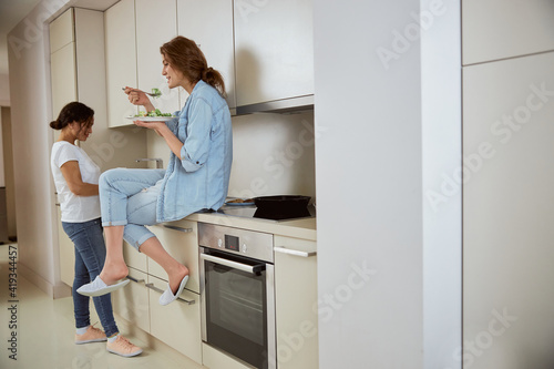 Relaxed female person sitting on the furniture