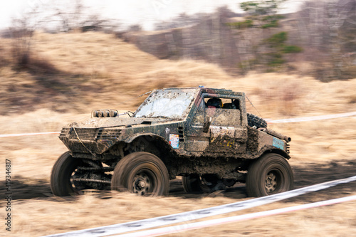 Dirty 4x4 vehicle starting in a off road competition. Dynamic shot of car on in the off road circuit race