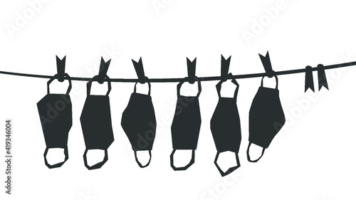  Medical masks hang on a rope. Quarantine coronavirus over concept. lockdown ending idea. Black White