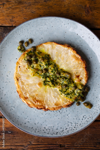 Roasted celeriac steak with capers and herb sauce