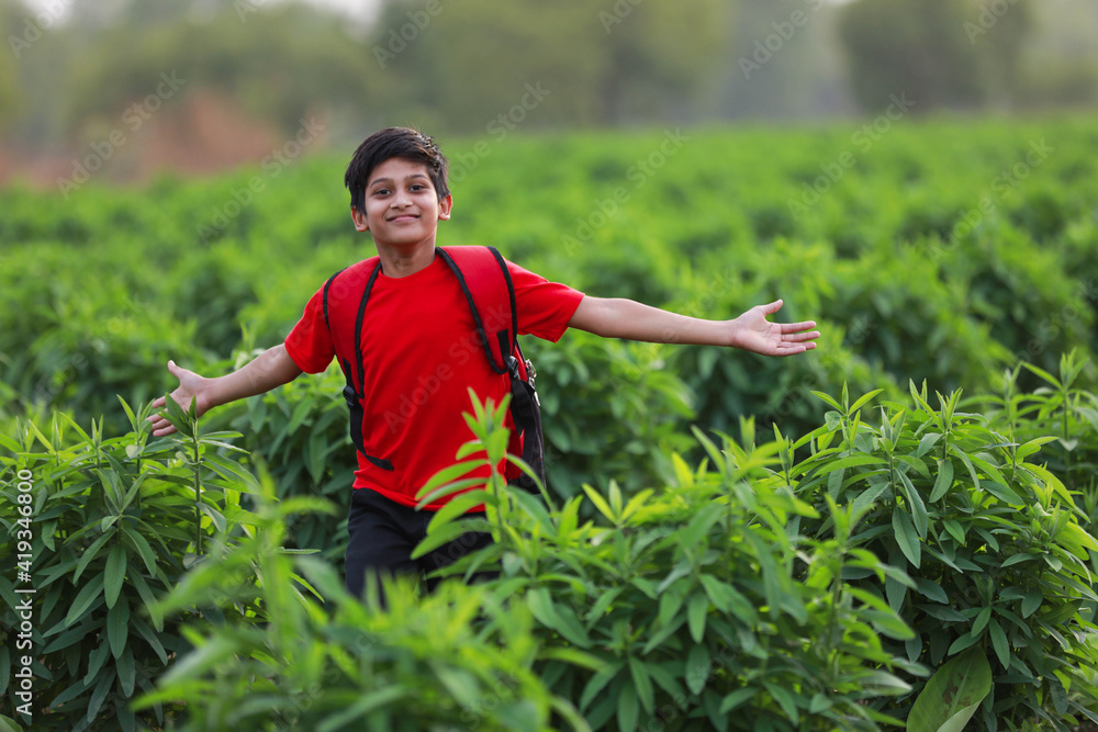 Cute indian child with sack bag at agriculture field Cute indian child with sack bag at agriculture field