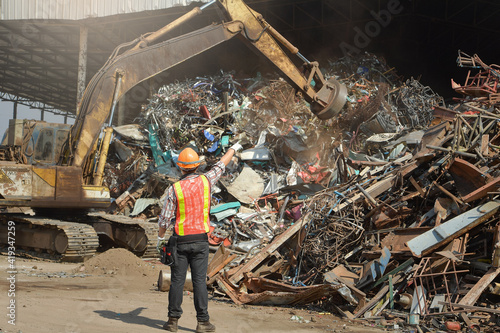 Recycling industry a worker who recycling thing on recycle center.Manager and Manual Worker in Metal Landfill