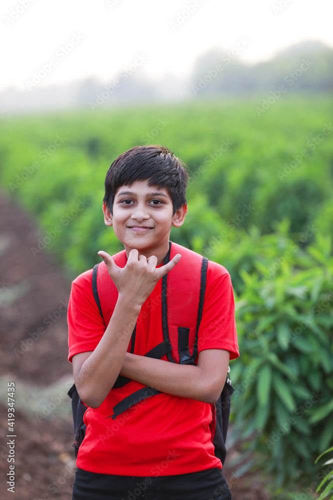 Cute indian child with sack bag at agriculture field Cute indian child with sack bag at agriculture field