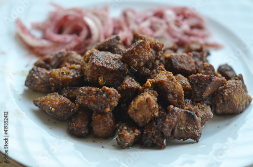 Photography Pan fried beef liver with seasoned onion salad