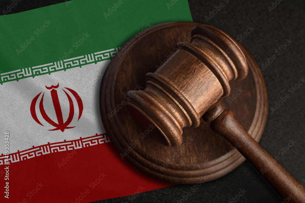 Judge gavel and flag of Iran. Law and justice in Iran. Violation of rights and freedoms