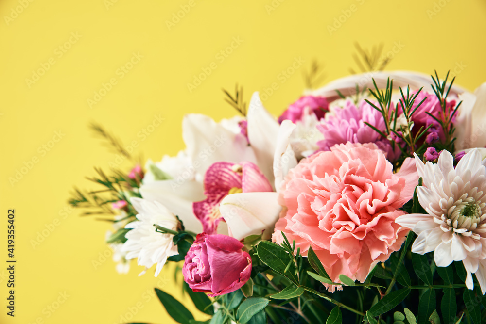 Bunch of fresh summer flowers on the yellow background