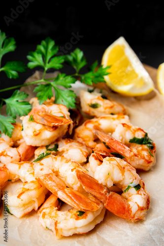  Fried shrimps with lemon close up, vertical photo soft focus
