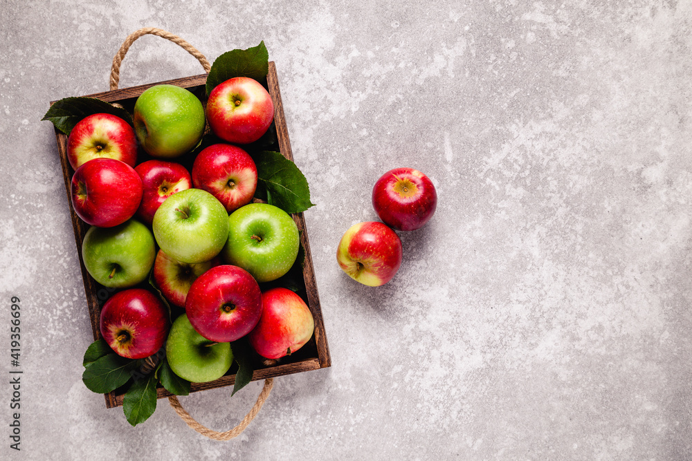 Ripe red and green apples in wooden box. Ripe red and green apples in wooden box.