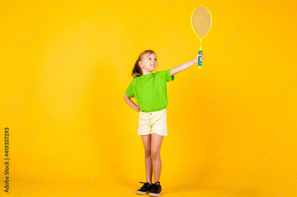 cute child play tennis or badminton. active way of life. full of energy. beautiful teen girl with tennis racquet. kid sport fashion style. fitness and health. happy childhood. Sport is our life cute child play tennis or badminton. active way of life. full of energy. beautiful teen girl with tennis racquet. kid sport fashion style. fitness and health. happy childhood. Sport is our life