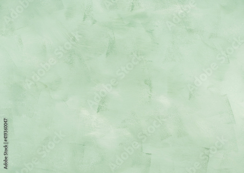 Pastel green textured painted concrete background for invitations and banners. © tenkende