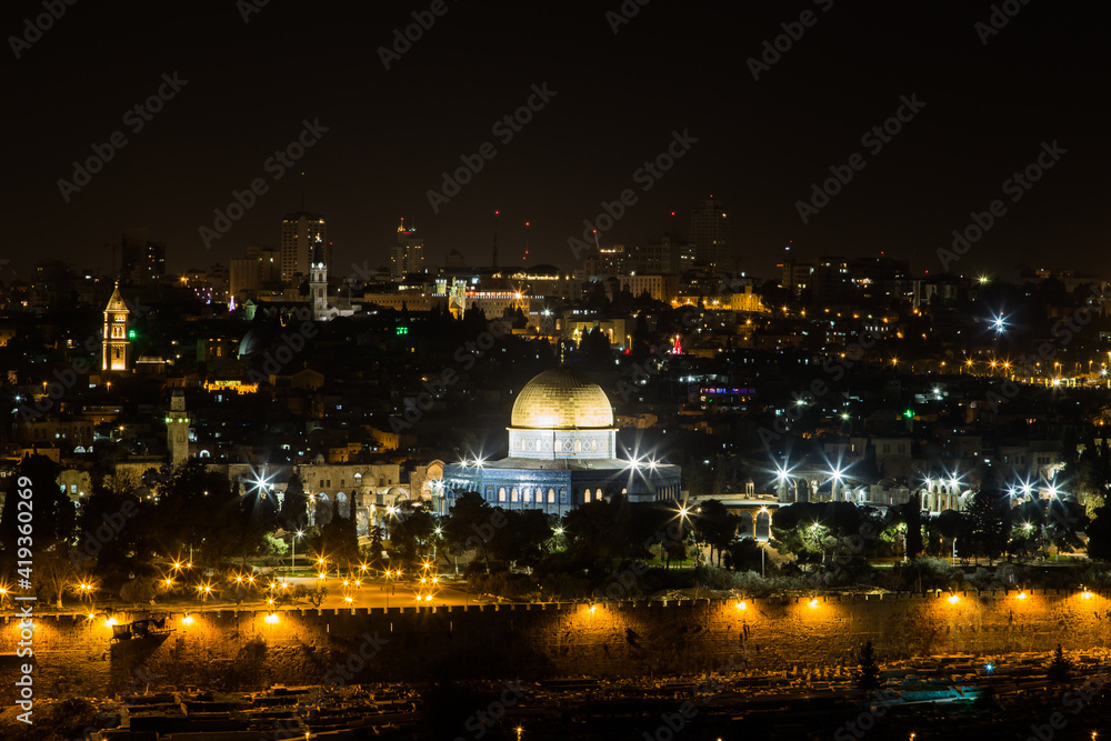 Dome of the Rock Mosque in Jerusalem at night. Night view from the Olive Mountain. Cityscape of the Old City of Jerusalem at the evening.
