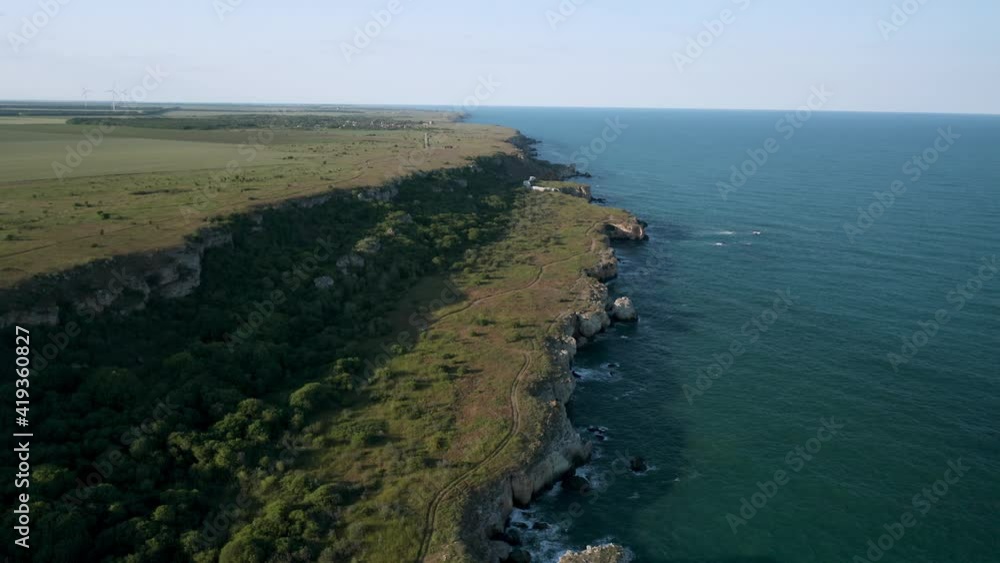 Panoramic video of picturesque rocky coastline with green fields and trees. Spring time at the Black sea coast, Yailata - national archeological and nature reserve, Bulgaria