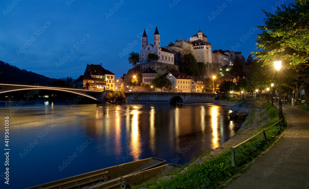 night view of town with river, bridge and church on the rock / Aarburg, Switzerland