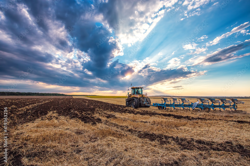 Fototapeta premium Tractor plowing the fields