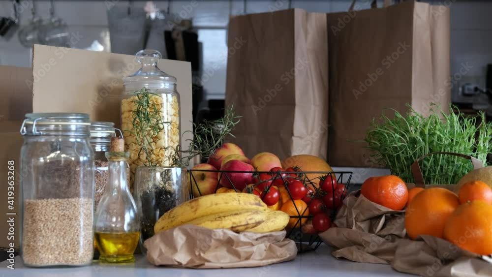 Healthy food groceries in glass jar and eco paper zero waste bags. No plastic and eco friendly concept. Vegan Lifestyle. Reduce Reuse Recycle 4K. New trend alternative buying. Healthy food groceries in glass jar and eco paper zero waste bags. No plastic and eco friendly concept. Vegan Lifestyle. Reduce Reuse Recycle 4K. New trend alternative buying.