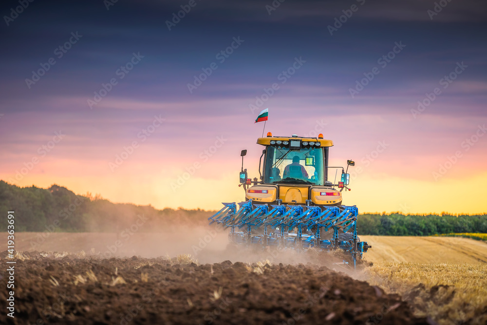 Fototapeta premium Tractor plowing the fields
