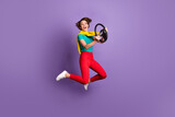 Full length photo of girl jump run hold steering wheel wear t-shirt pants footwear isolated violet color background