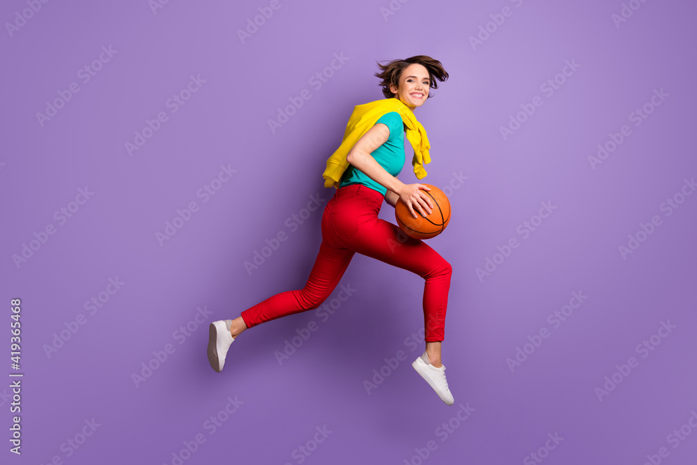 Full length profile photo of lady jump run hold ball wear t-shirt pants footwear isolated purple color background