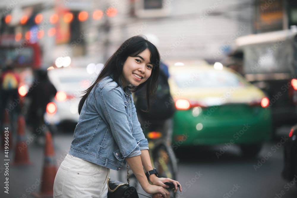 Beautiful Asian woman who has long hair travels to the festival at Yaowarat Chinatown in Thailand. Street photography of traveler woman at night.