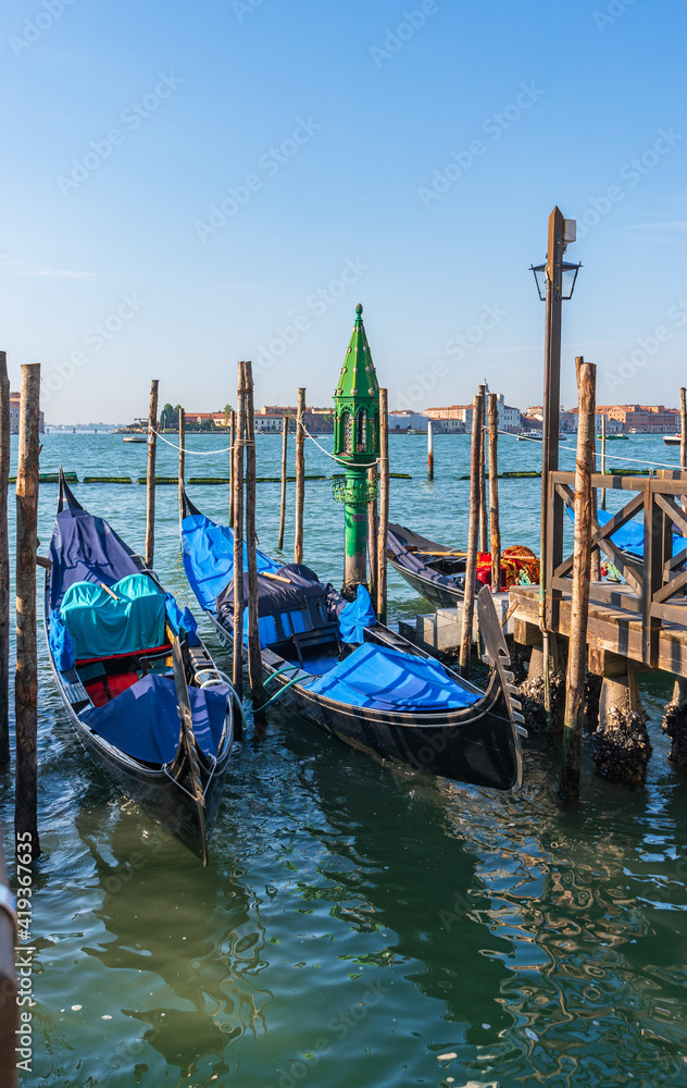 Venice, Italy. Gondolas at the pier in the morning on a summer day.