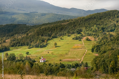 panoramic landscape with white christian church in the Carpathian mountains in the spring