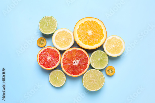 Fresh juicy citrus fruits on light blue background  flat lay