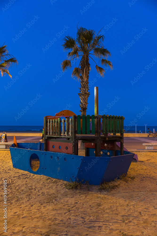 playground for kids at sunrise with beautiful colors at malvarosa beach of the City of valencia, costa blanca, spain