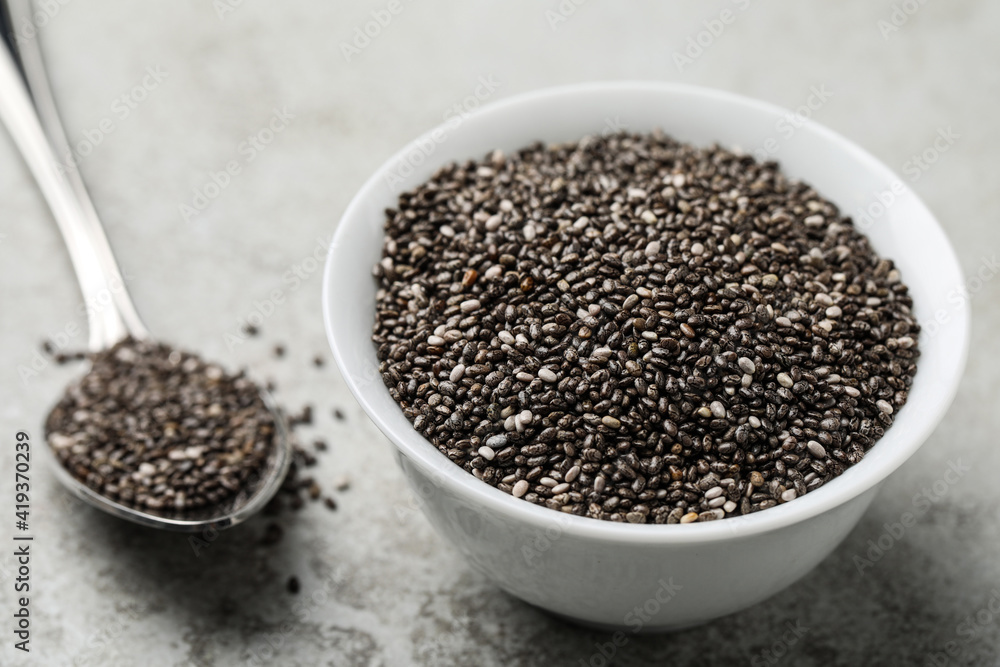 Bowl with chia seeds on grey table Bowl with chia seeds on grey table