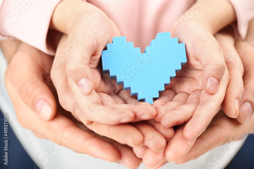 Wallpaper Mural Parents and kid holding blue heart in hands, closeup. Family day Torontodigital.ca