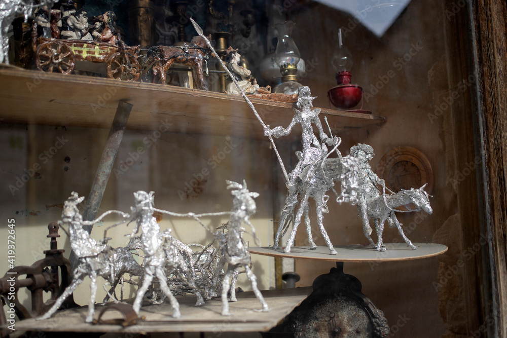 Handmade aluminum foil figures displayed on a window shelf Handmade aluminum foil figures displayed on a window shelf