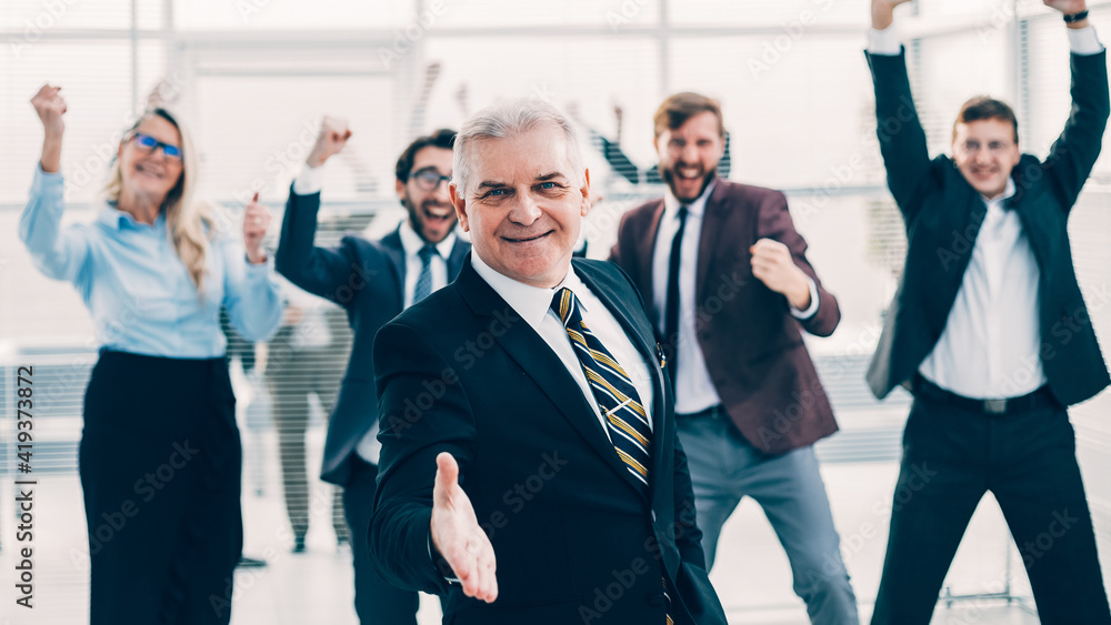 senior business man holding out his hand for a handshake. senior business man holding out his hand for a handshake.