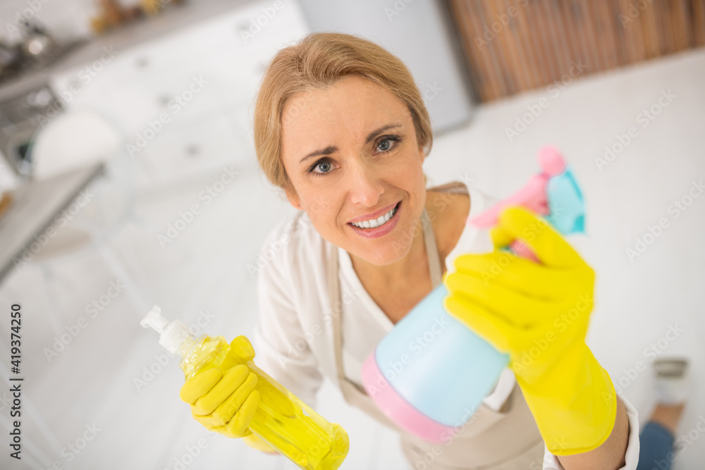 Housewife in apron and gloves looking annoyed Housewife in apron and gloves looking annoyed
