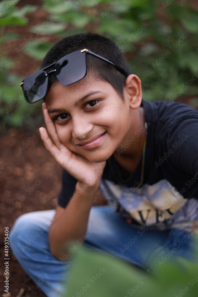 Cute indian little child wearing sunglasses and giving expression