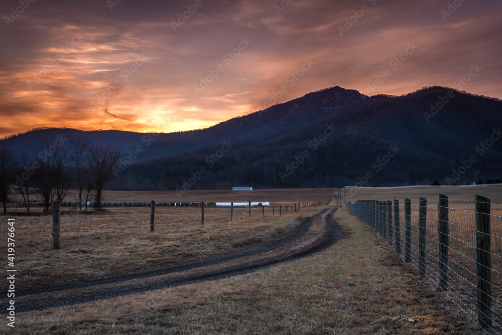 Sunset behind Old Rag Mountain viewed from an old dirt road on a farm outside of Shenandoah National Park.