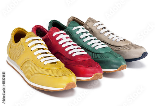 Group of four well-made sneakers with colored soles