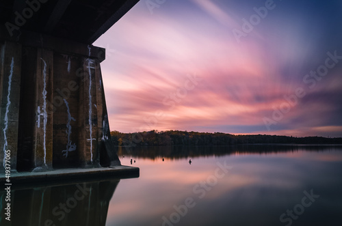 A railroad bridge spanning a waterway at Leesylvania State Park at sunset.