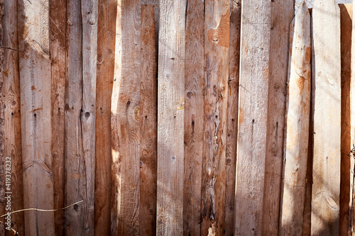 Wooden fence made of wooden narrow boards. Background and texture © keleny