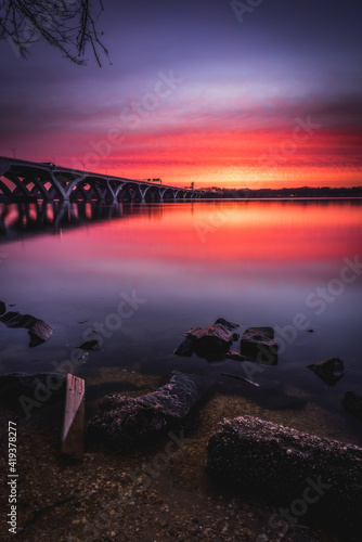 An intense sunrise in Alexandria looking across the Potomac River into Maryland, next to the Woodrow Wilson Bridge.