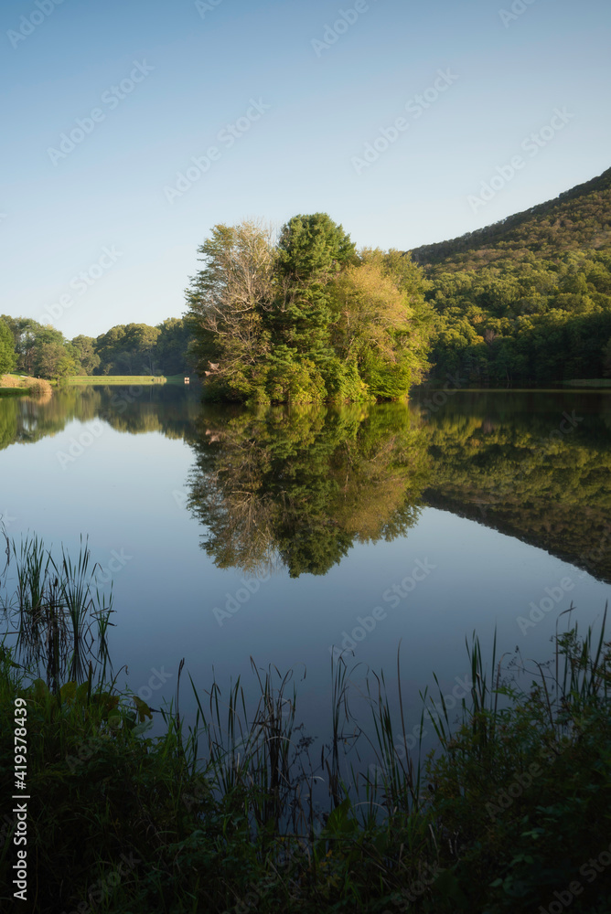 Late afternoon at Abbott Lake within the Peaks of Otter as the island of trees reflections flawlessly in the calm lake.