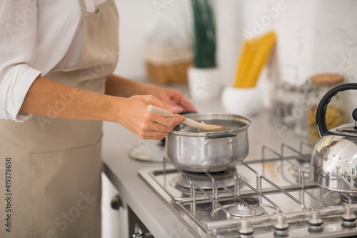 Woman in apron cooking in the kitchen