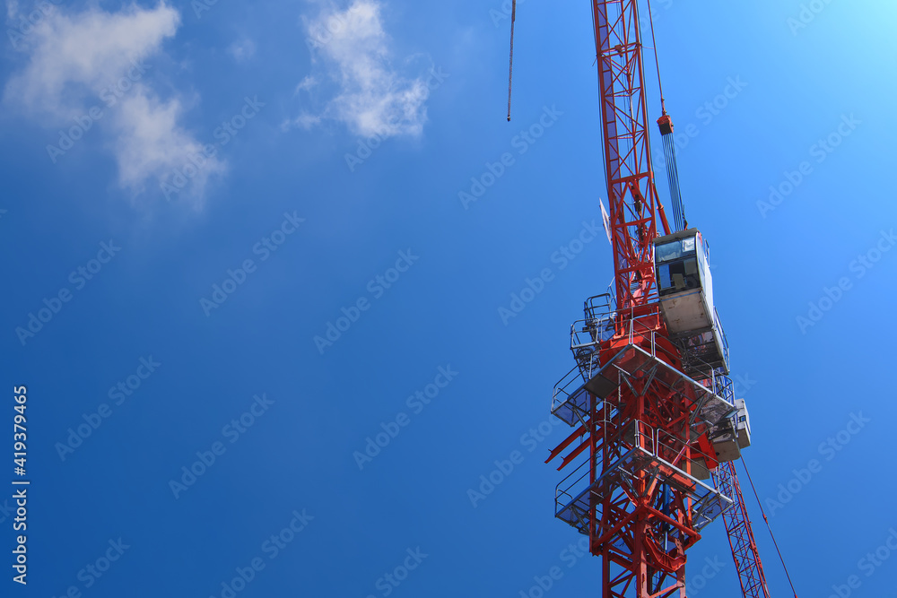 Cranes high-rise, Construction site, On backdrop of blue sky and sunrise morning with copy space, Industrial machine engine and mechanical outdoor workplace. Cranes high-rise, Construction site, On backdrop of blue sky and sunrise morning with copy space, Industrial machine engine and mechanical outdoor workplace.