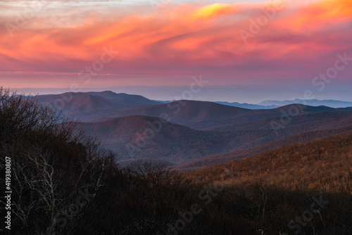 Vivid and colorful clouds during a sunrise over Shenandoah National Park viewed from Mount Marshall in the Winter.