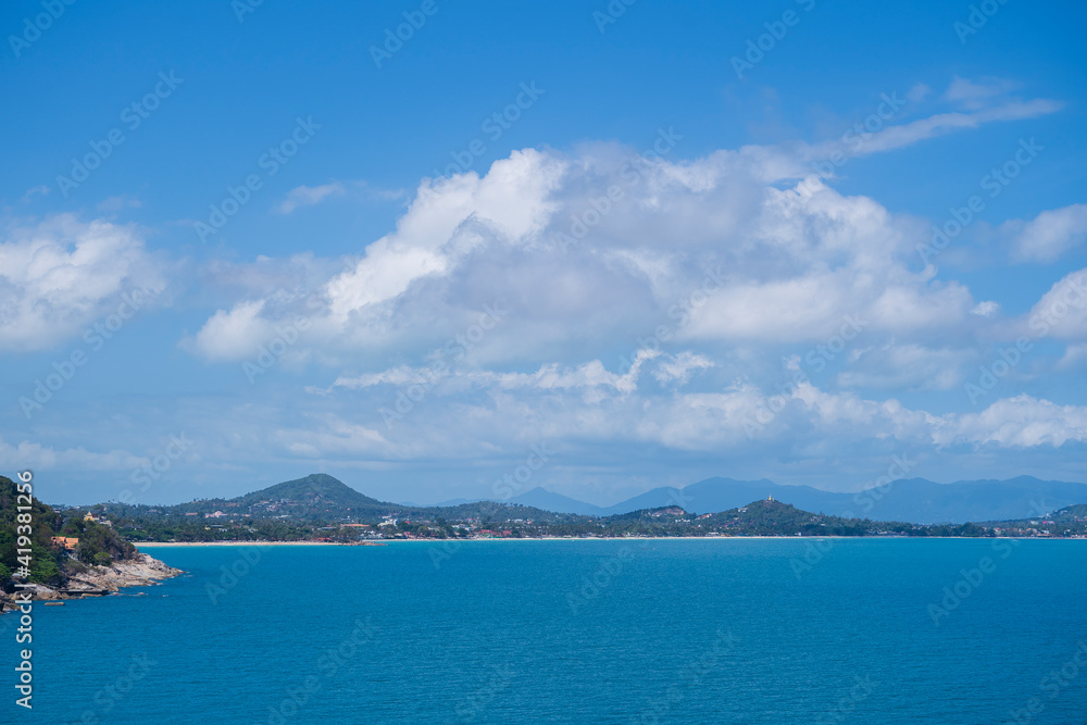 Beautiful scenery at view point of island Koh Samui in Thailand. Travel and nature concept. Sea water, mountains and blue sky with white clouds