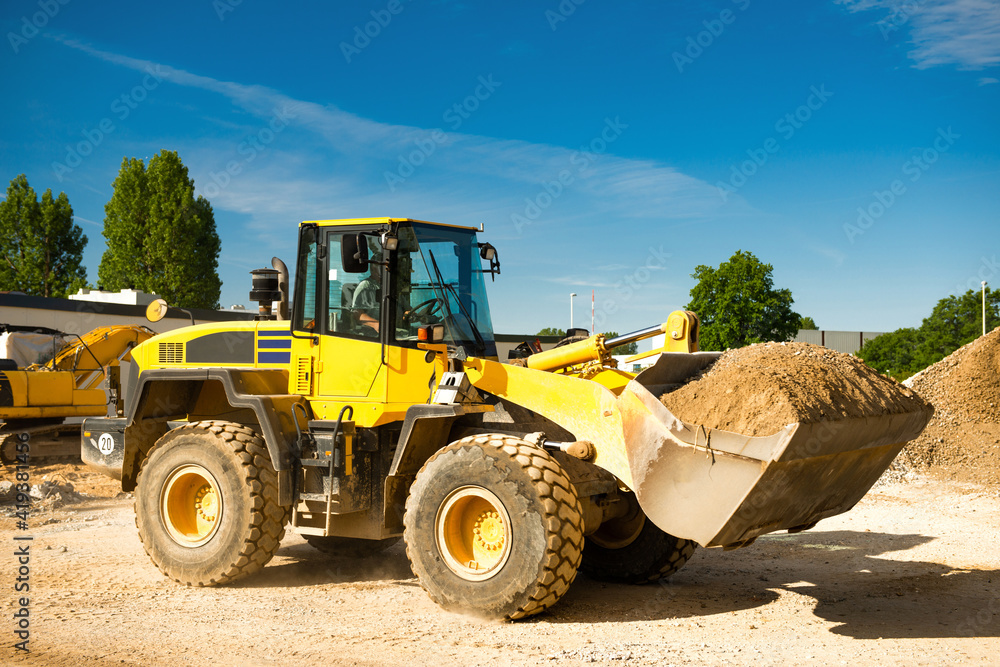 Wheel loader transports gravel on a construction site 2830
