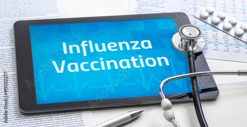 The word Influenza Vaccination on the display of a tablet