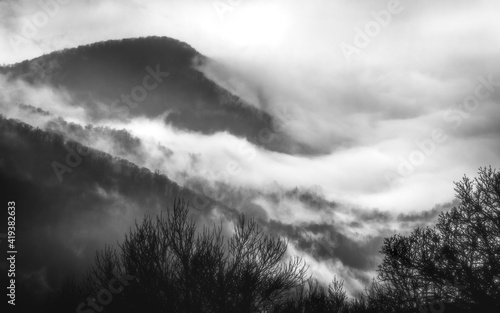 An abstract image of fog billowing around a mountain peak in Shenandoah National Park on a weather filled day in the Winter.